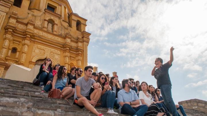 Professor speaks to a group of Trinity students gathered on the steps of the Cerro del Obispado, a famous landmark in Monterrey, Mexico