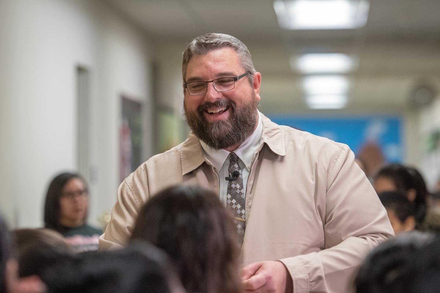 Brian Pennartz with students in hallway