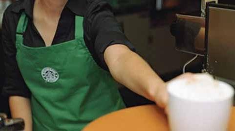 Worker serving coffee